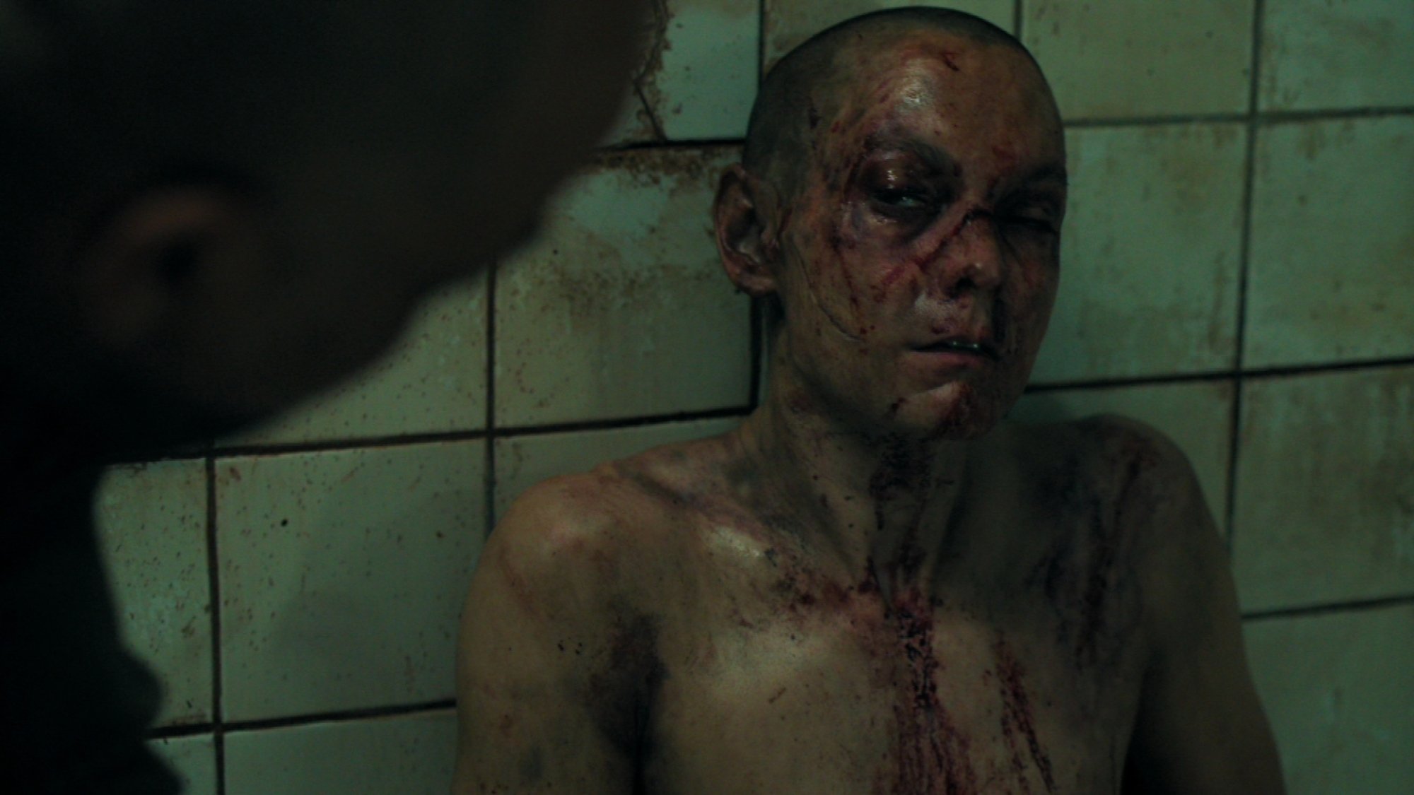 A Seraphite (Ryan Masson) looks brutally wounded in