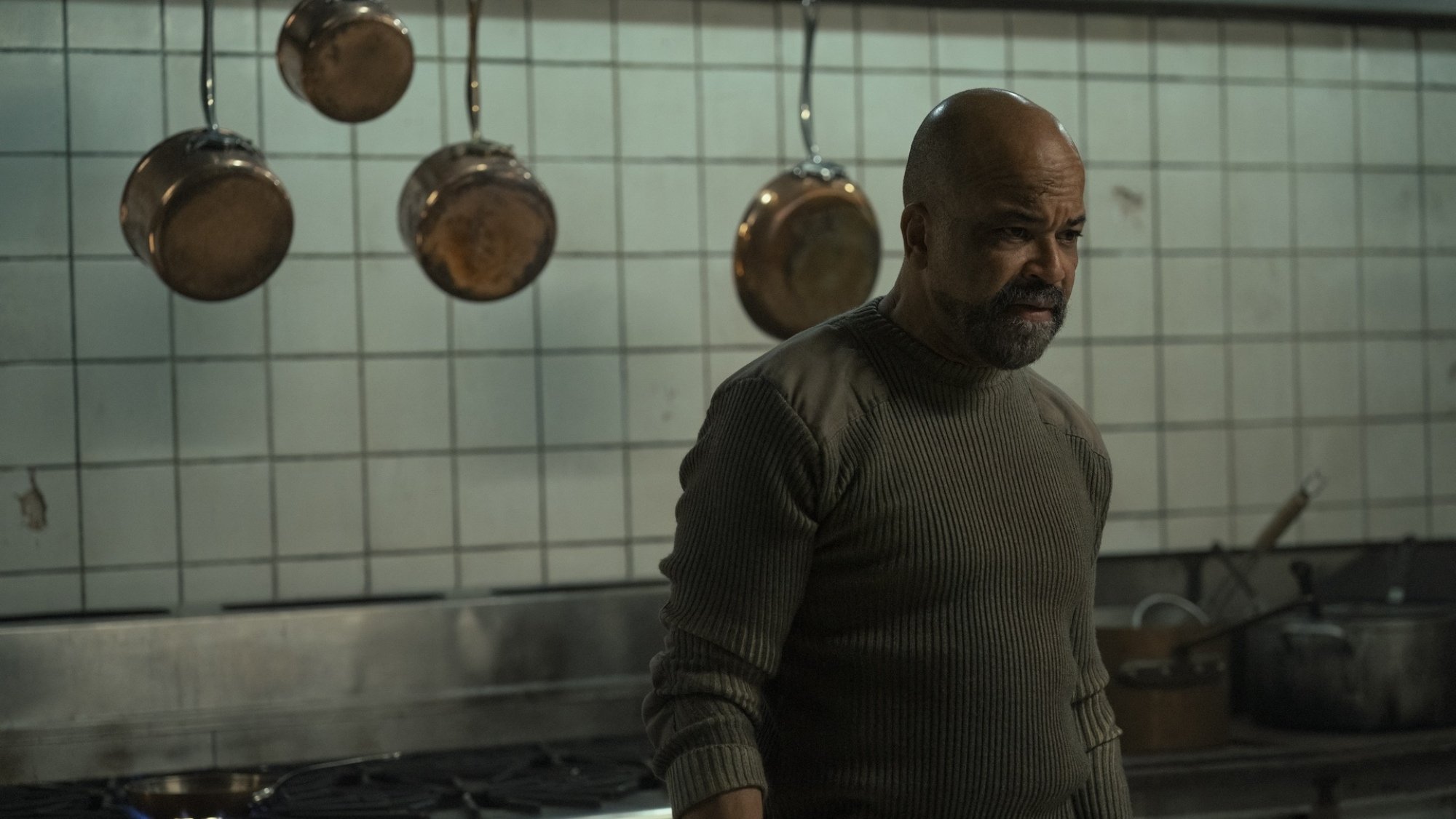 Isaac (Jeffrey Wright) stands looking serious in a kitchen in