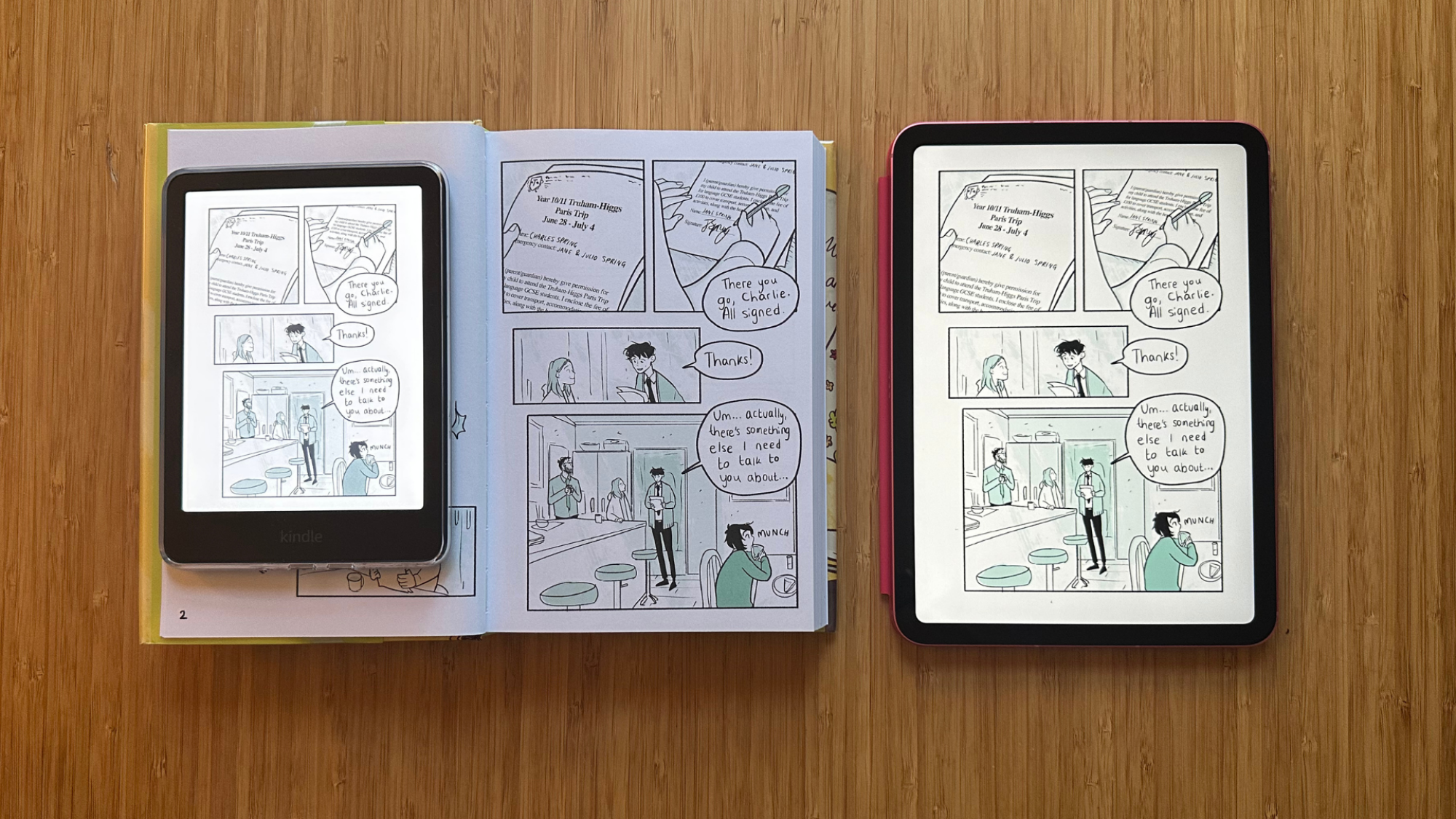 A Kindle Colorsoft, Heartstopper Volume 3, and iPad all next to each other on a table.