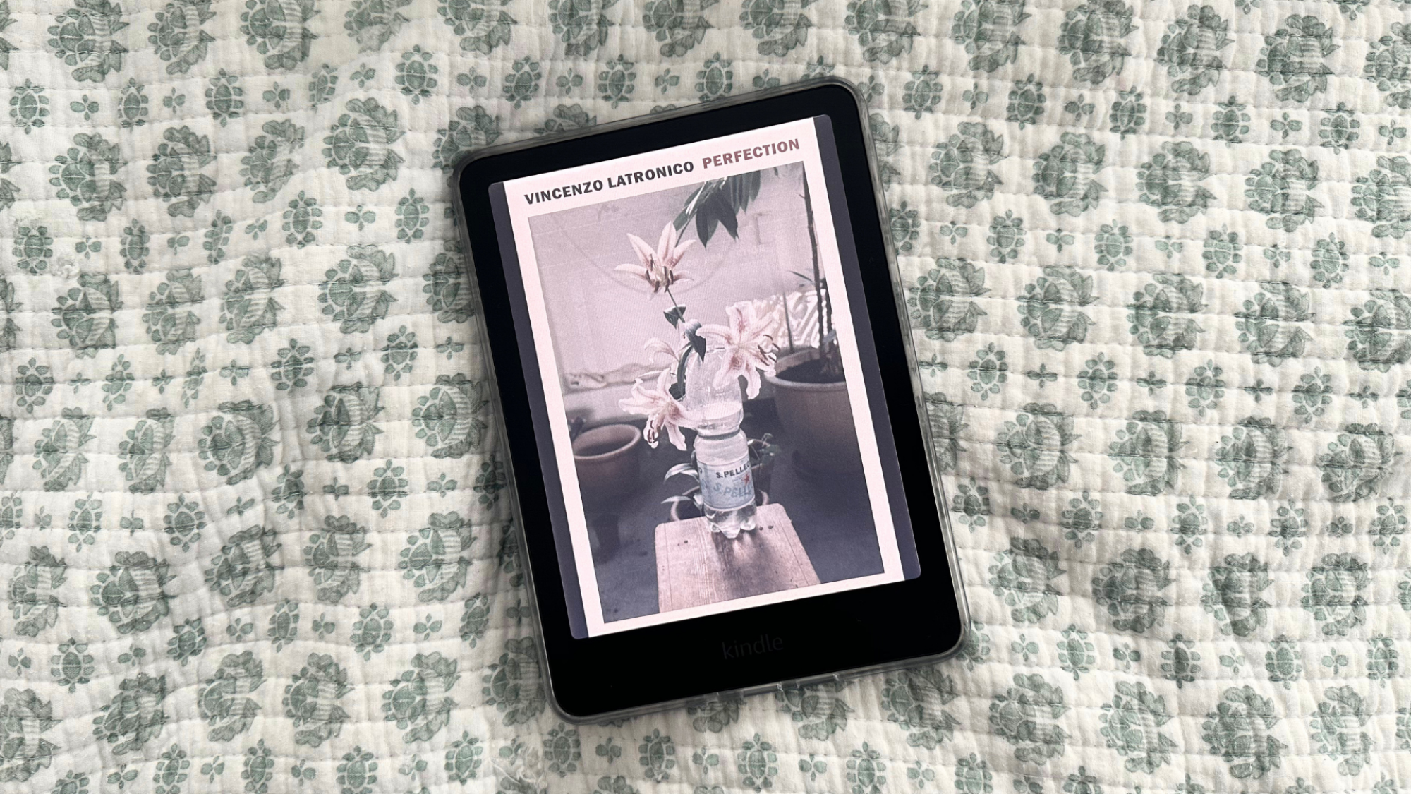 A Kindle Colorsoft laying on a quilt.