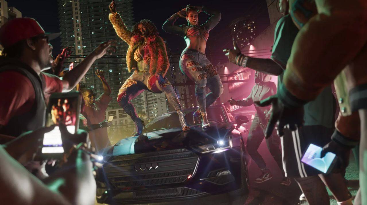 A crowd of NPCs in GTA 6 watches as two women dance on top of a car.