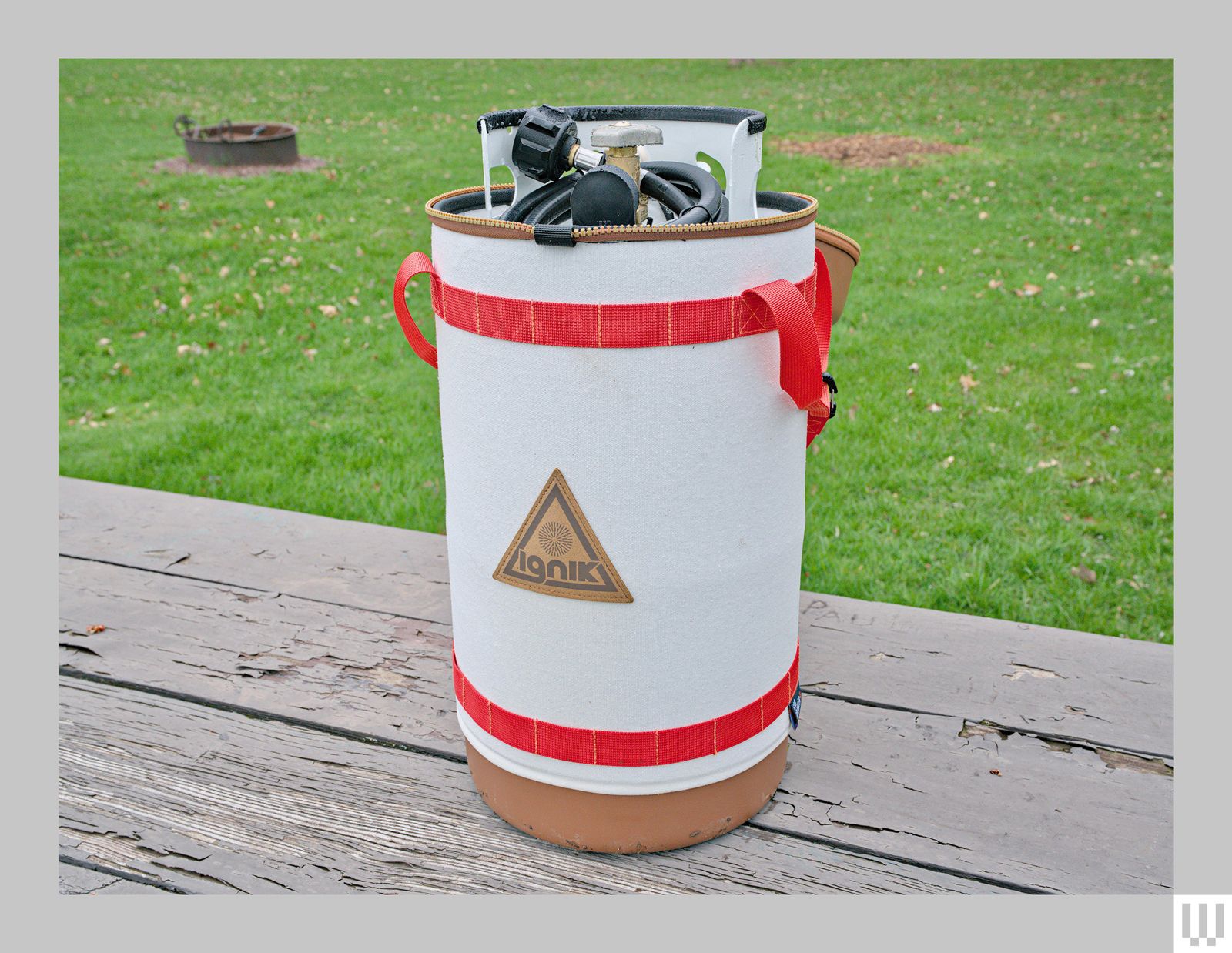 Porpane tank in a large carrying bag with red straps