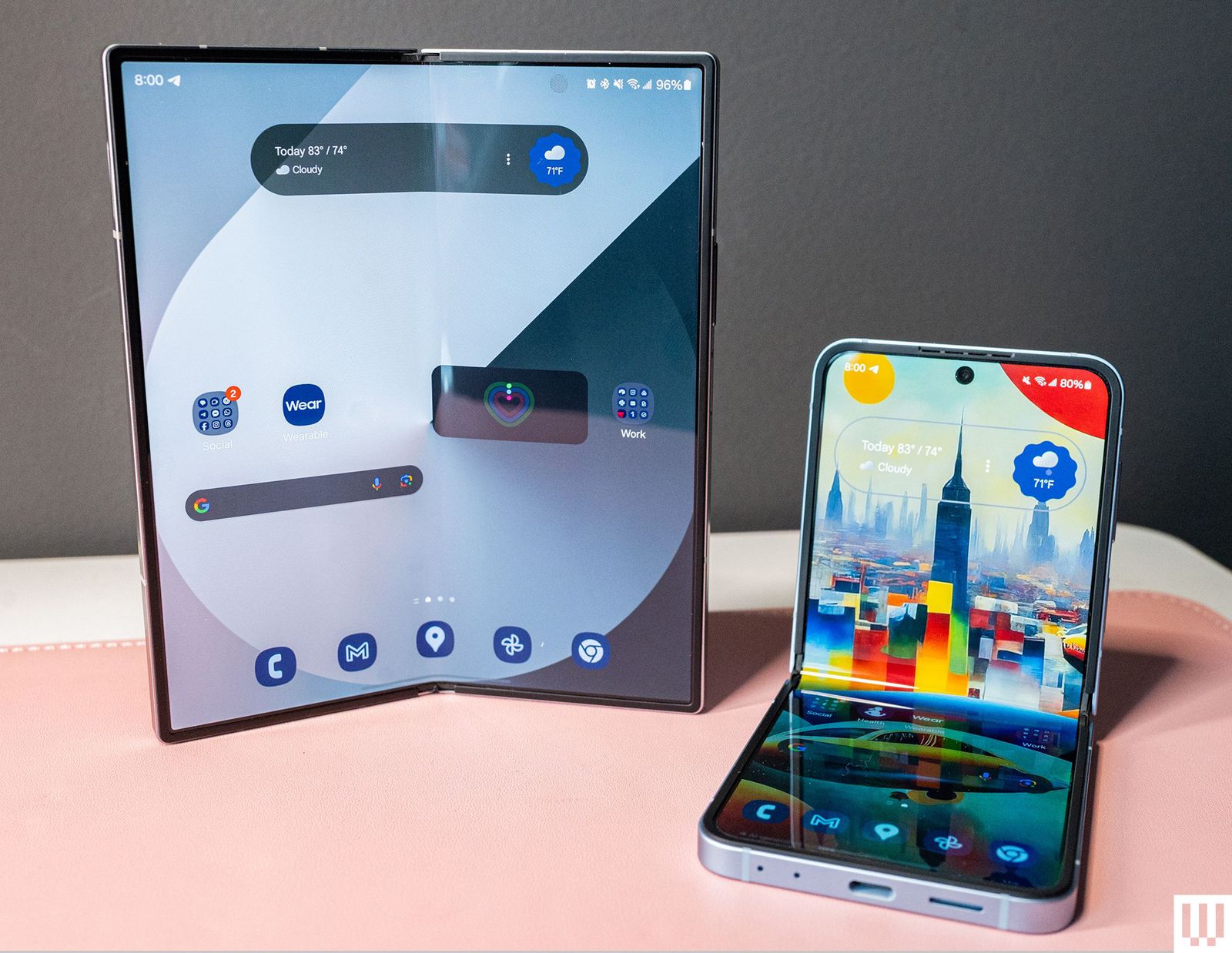 Two foldable mobile phones side by side with one in the vertical upright. position  and the other in an Lshaped hinge...